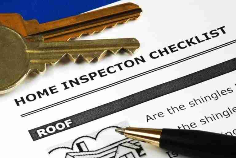 Home inspection checklist with keys and pen.
